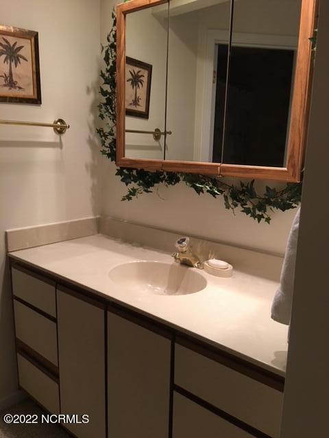 5112 B Greenville Loop Road, Unit B Wilmington, NC 28409 - Photo 13 of 16 Vanity in Primary bedroom