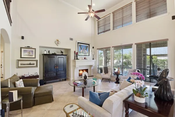 a living room with furniture fireplace and a large window