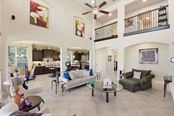 a living room with furniture and a floor to ceiling window