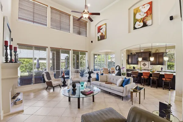 a living room with furniture ceiling fan and a floor to ceiling window