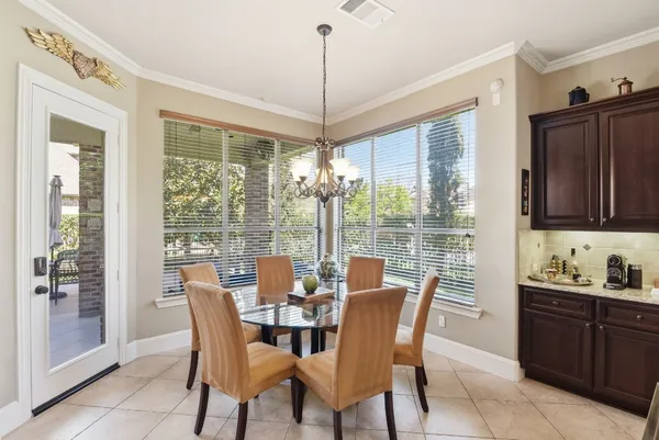 a view of a dining room with furniture large windows and wooden floor