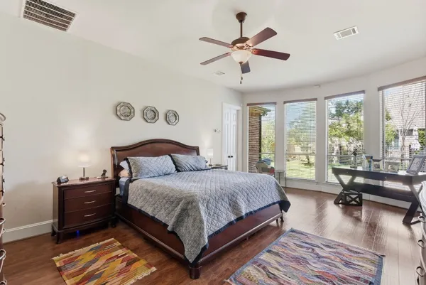 a bedroom with a large bed and a chandelier
