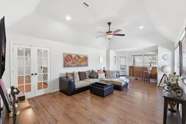 a living room with furniture a fireplace and wooden floor