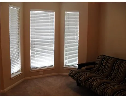 a view of a bedroom with a bed and a window