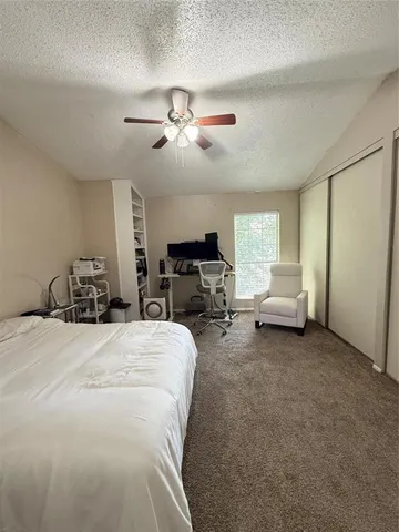 a bed room with furniture and a flat screen tv