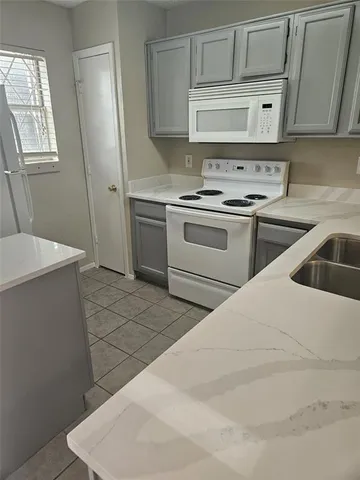 a kitchen with a stove and a refrigerator