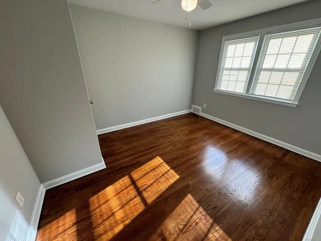 a view of an empty room and wooden floor