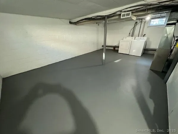 a view of walk in closet with clothes