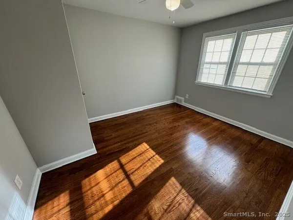 a view of an empty room and wooden floor