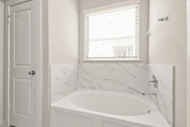 a white bath tub sitting next to a window