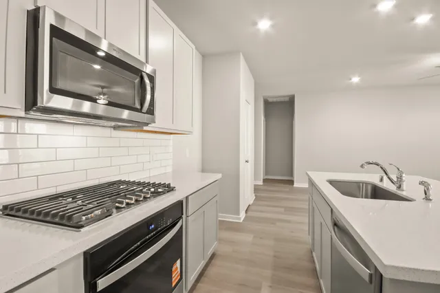 a kitchen that has a sink and a stove