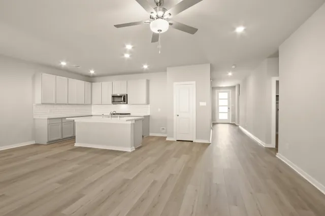 a view of a kitchen with wooden floor and a kitchen