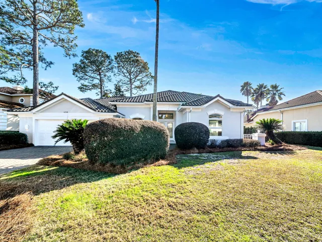 a view of a house with backyard porch and sitting area