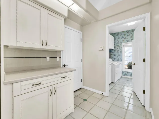 a view of a hallway with wooden shelves