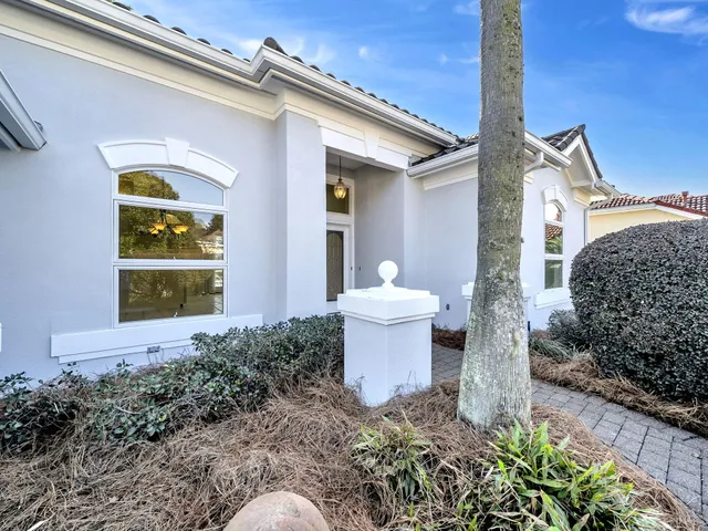 an aerial view of a houses with a swimming pool