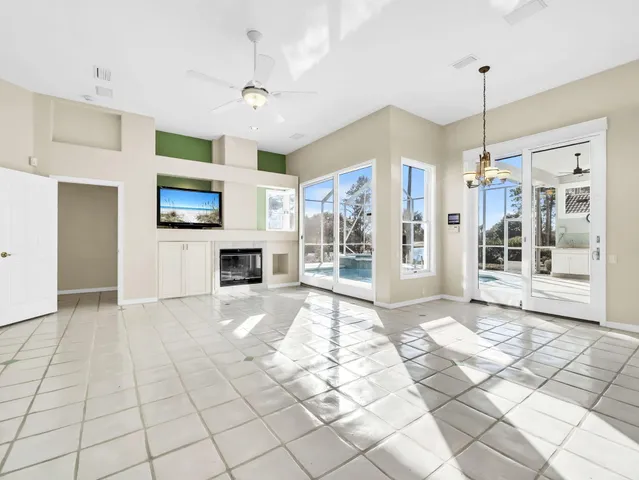 a view of a livingroom with wooden floor and a fireplace