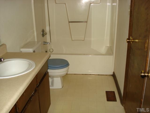2528 Edgemont Road Wendell, NC 27591 - Photo 8 of 9 a bathroom with a sink a toilet and a bathtub