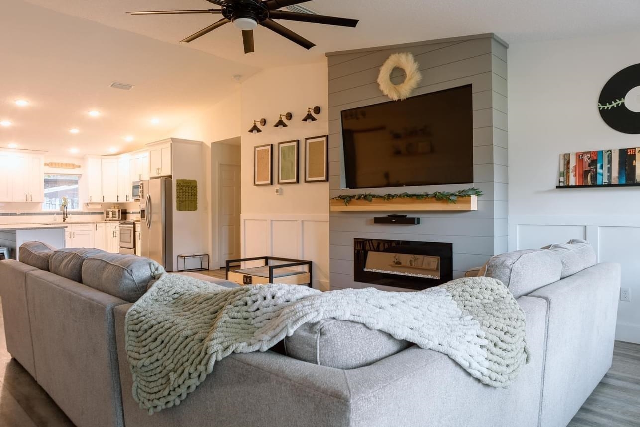 1148 Prince Road St. Augustine, FL 32086 - Photo 2 of 12 a living room with furniture a flat screen tv and a fireplace