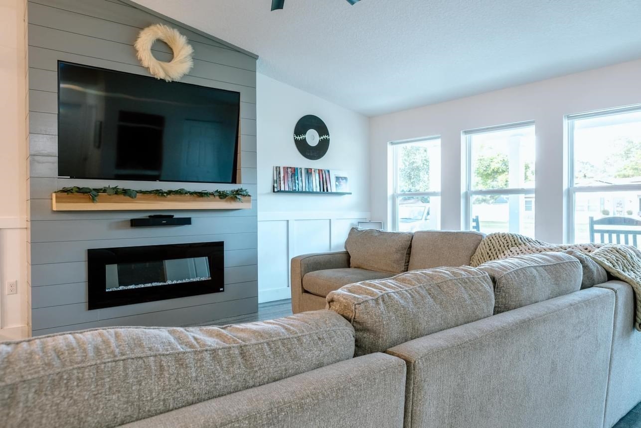 1148 Prince Road St. Augustine, FL 32086 - Photo 6 of 12 a living room with furniture a flat screen tv and a fireplace