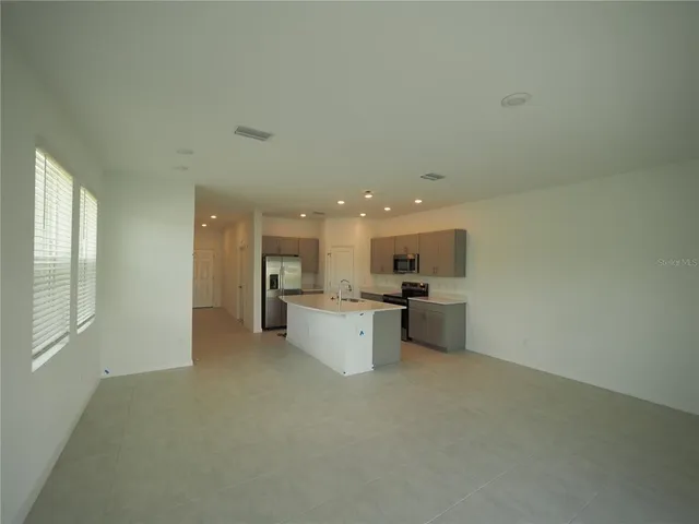 a view of a kitchen with a sink and microwave
