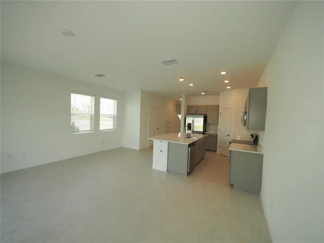 a view of a kitchen with a sink and microwave