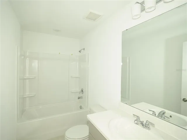 a bathroom with a shower and a sink