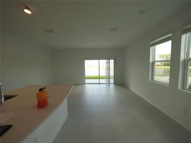 a view of a kitchen with a sink dishwasher and a fireplace