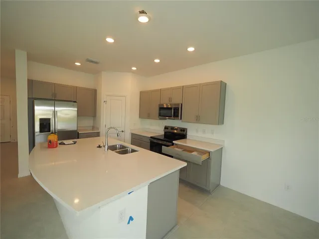 a kitchen with a sink a stove and cabinets
