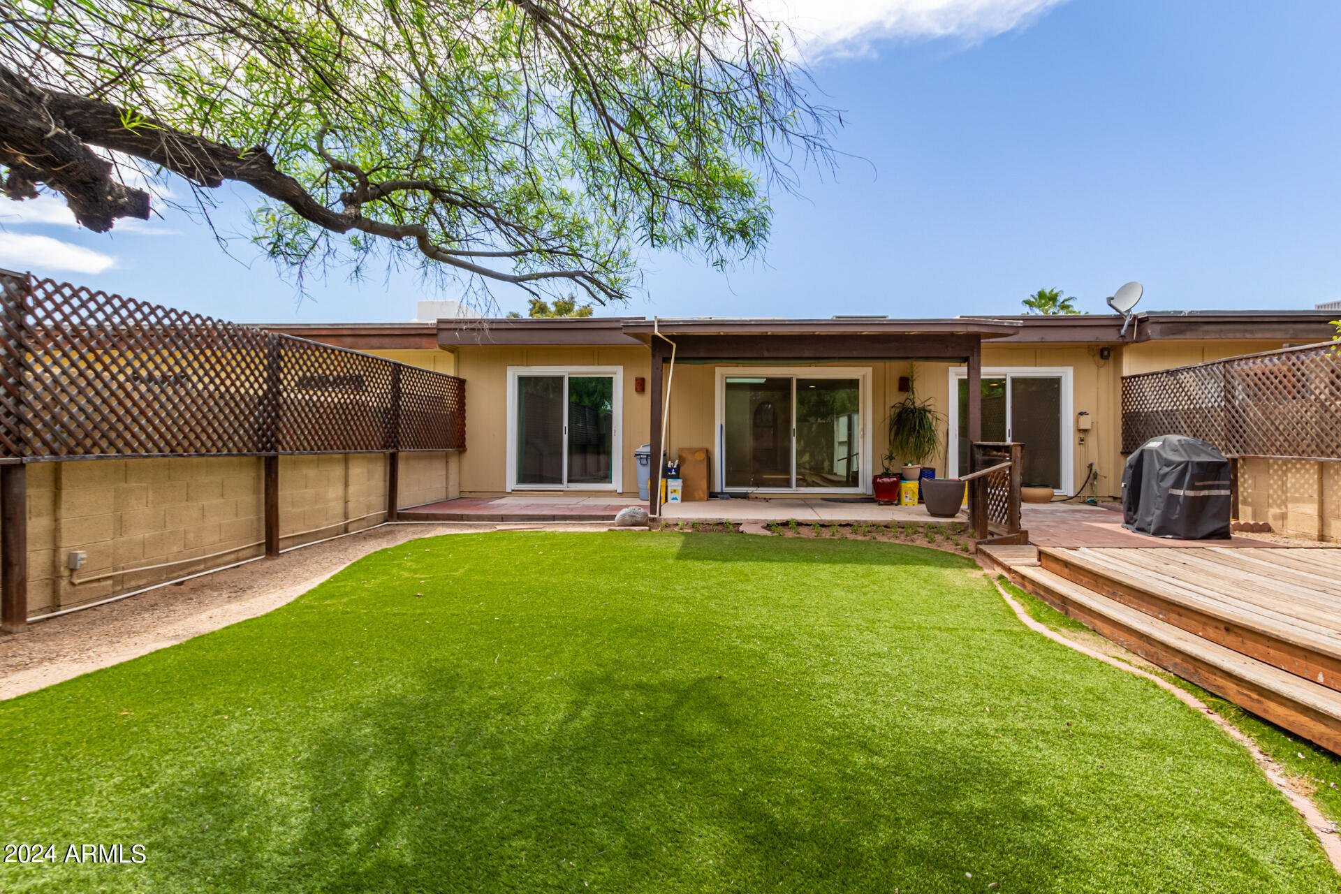 18035 North 24th Place Phoenix, AZ 85032 - Photo 21 of 22 a view of a house with a backyard porch and sitting area