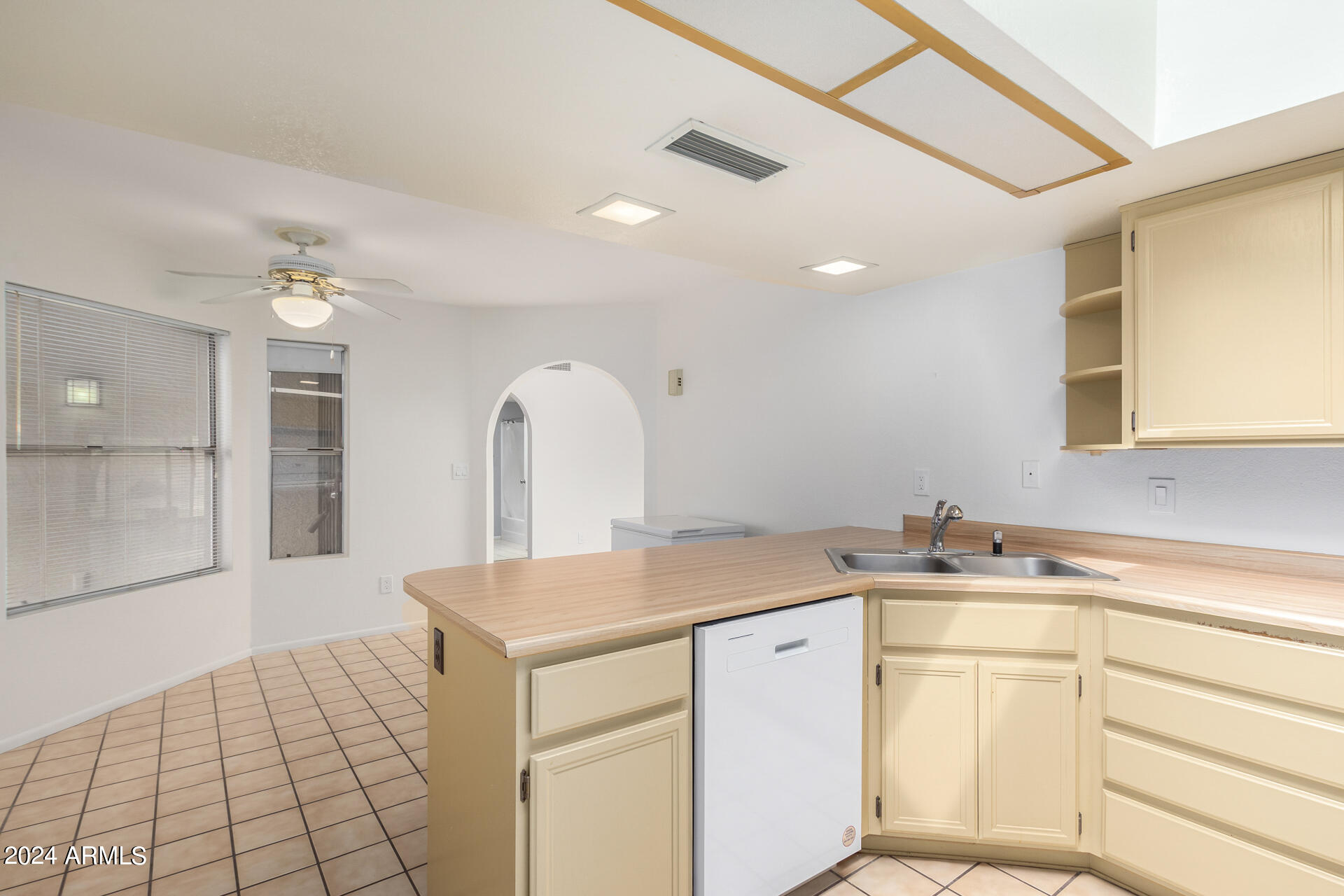 18035 North 24th Place Phoenix, AZ 85032 - Photo 6 of 22 a kitchen with a sink cabinets and wooden floor
