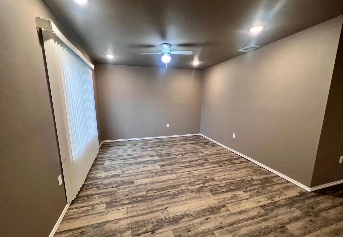 1516 East 8th Street Lubbock, TX 79403 - Photo 3 of 7 an empty room with wooden floor and staircase