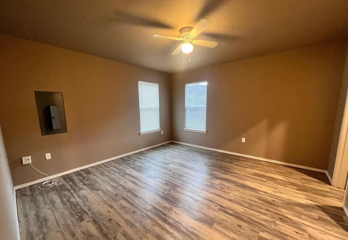 1516 East 8th Street Lubbock, TX 79403 - Photo 6 of 7 a view of an empty room with window and wooden floor