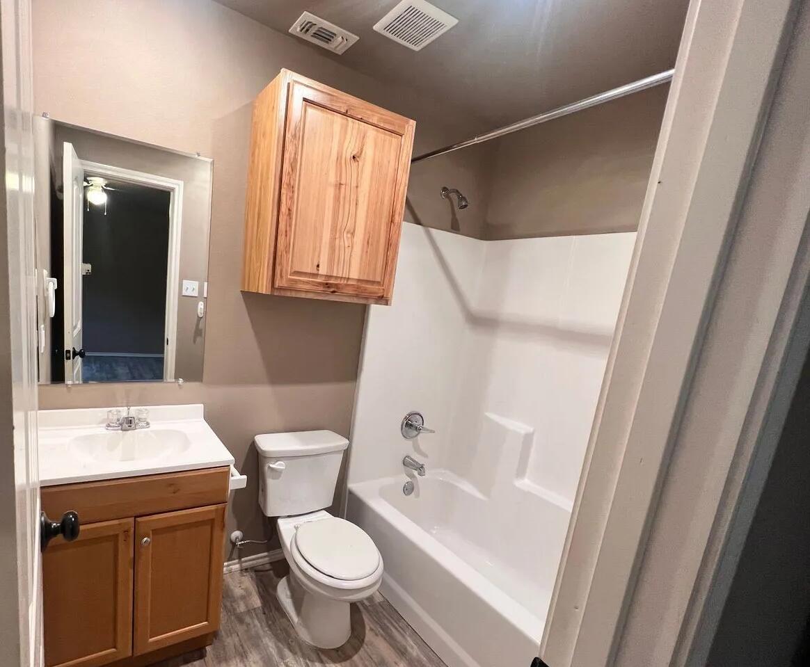 1516 East 8th Street Lubbock, TX 79403 - Photo 7 of 7 a bathroom with a sink toilet and shower
