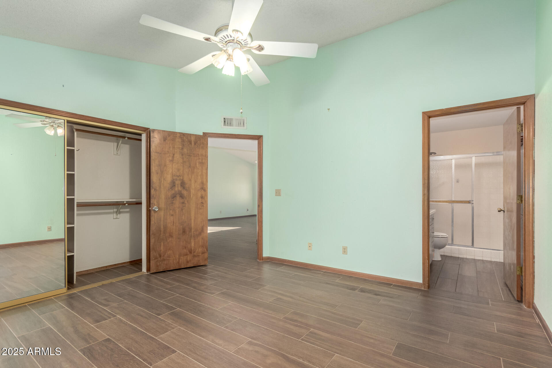 542 South Higley Road, Unit 3 Mesa, AZ 85206 - Photo 13 of 33 an empty room with wooden floor cabinet and windows