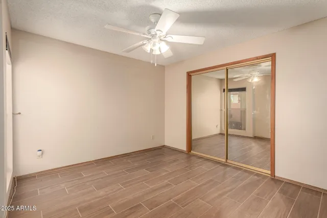 an empty room with fan and entryway
