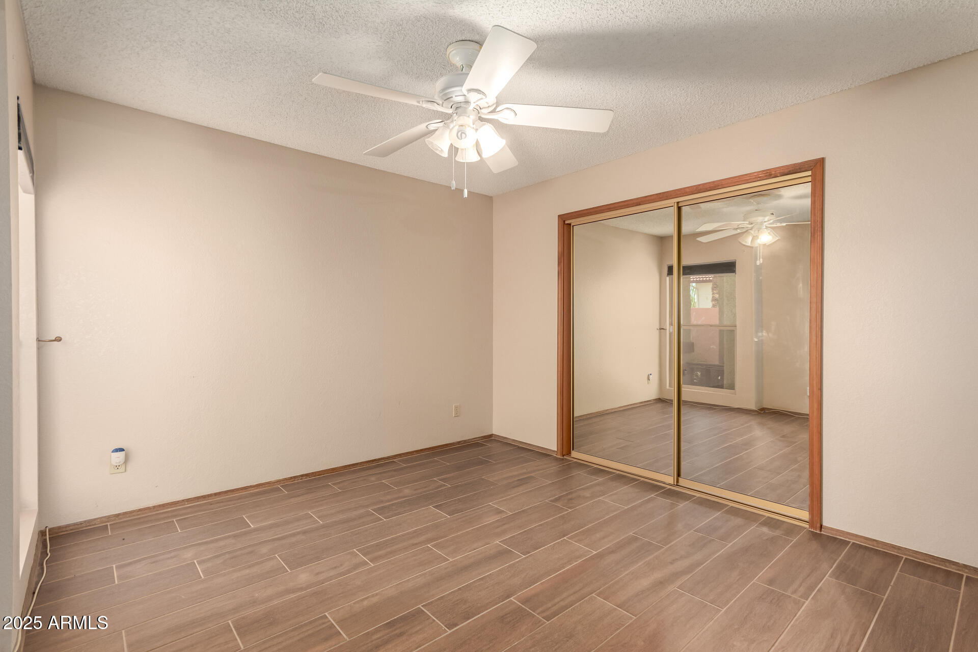 542 South Higley Road, Unit 3 Mesa, AZ 85206 - Photo 15 of 33 an empty room with fan and entryway