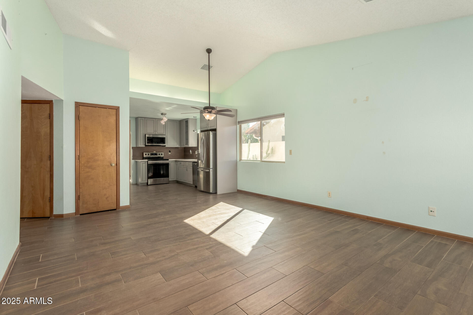542 South Higley Road, Unit 3 Mesa, AZ 85206 - Photo 3 of 33 a view of empty room with wooden floor and window