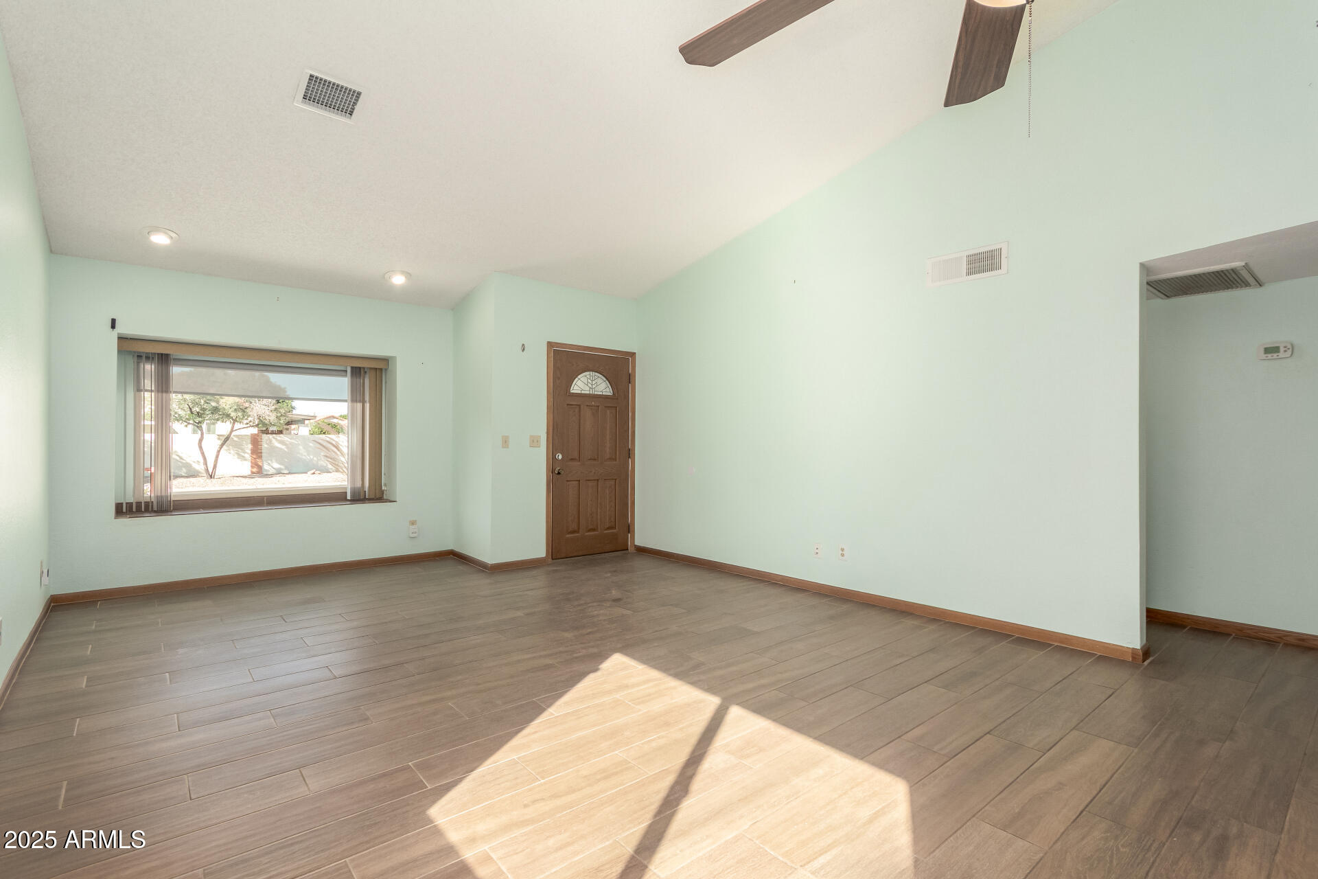542 South Higley Road, Unit 3 Mesa, AZ 85206 - Photo 4 of 33 wooden floor in an empty room with a window