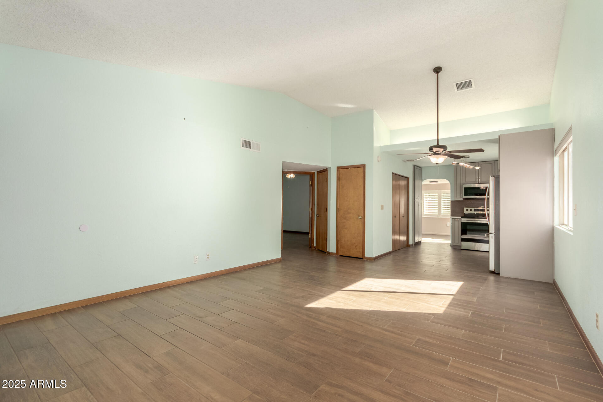 542 South Higley Road, Unit 3 Mesa, AZ 85206 - Photo 5 of 33 a view of a kitchen with a sink and a refrigerator