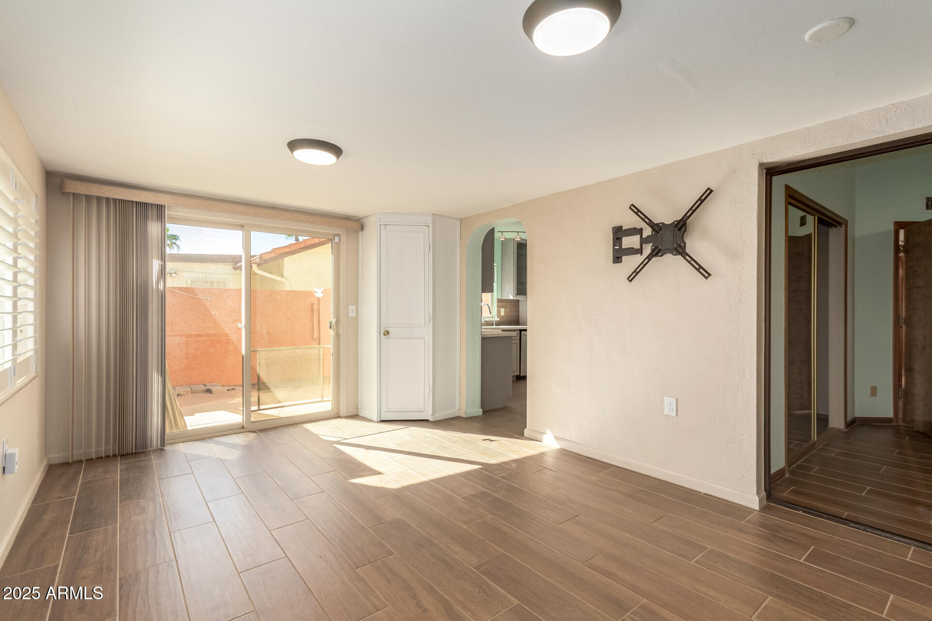 542 South Higley Road, Unit 3 Mesa, AZ 85206 - Photo 7 of 33 an empty room with wooden floor and windows