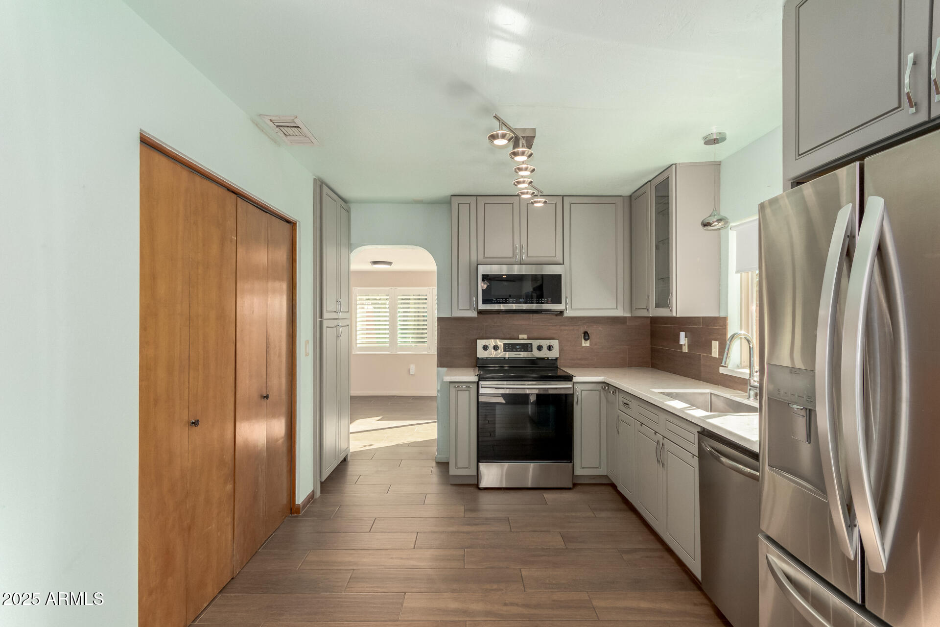 542 South Higley Road, Unit 3 Mesa, AZ 85206 - Photo 10 of 33 a kitchen with stainless steel appliances granite countertop a refrigerator stove and sink