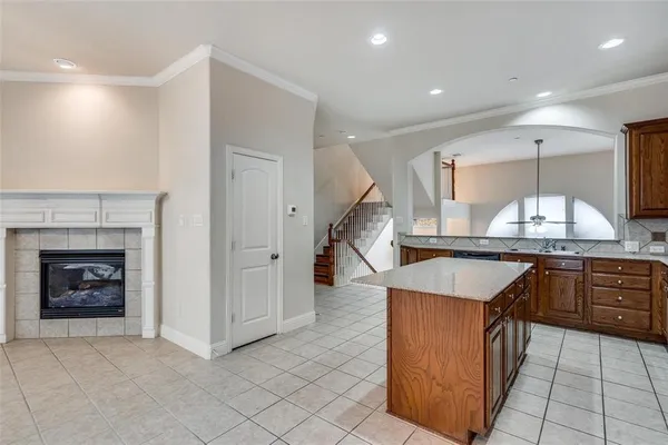 an empty room with windows and fireplace