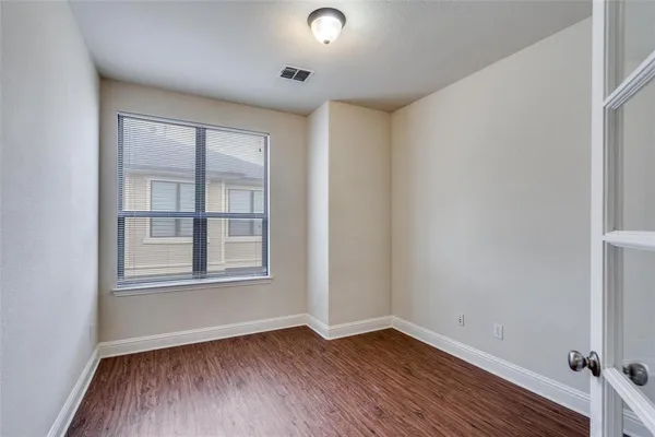 a view of workspace with wooden floor windows