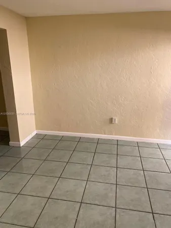a view of a kitchen space with wooden floor and a window