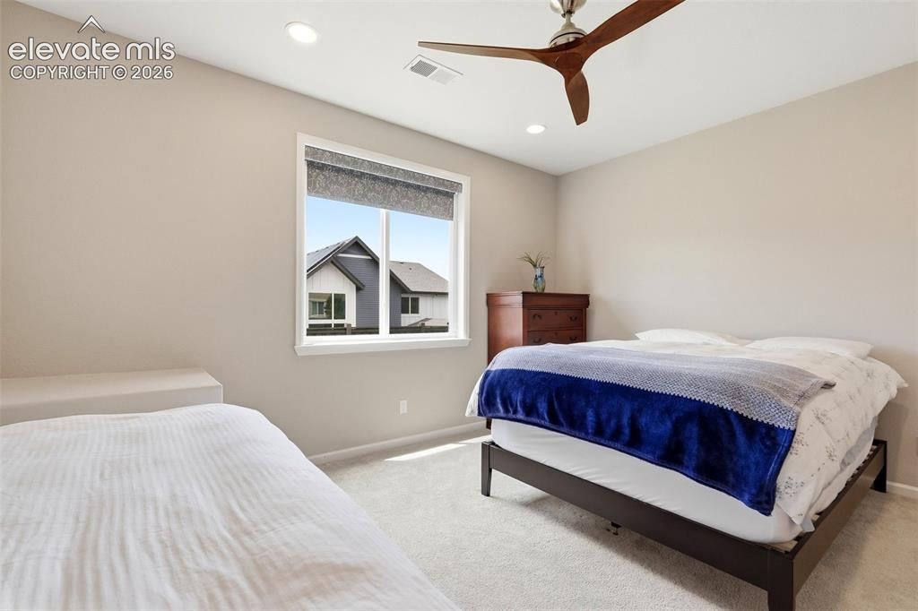1394 Promontory Bluff View Colorado Springs, CO 80921 - Photo 42 of 47 a spacious bedroom with a bed and window