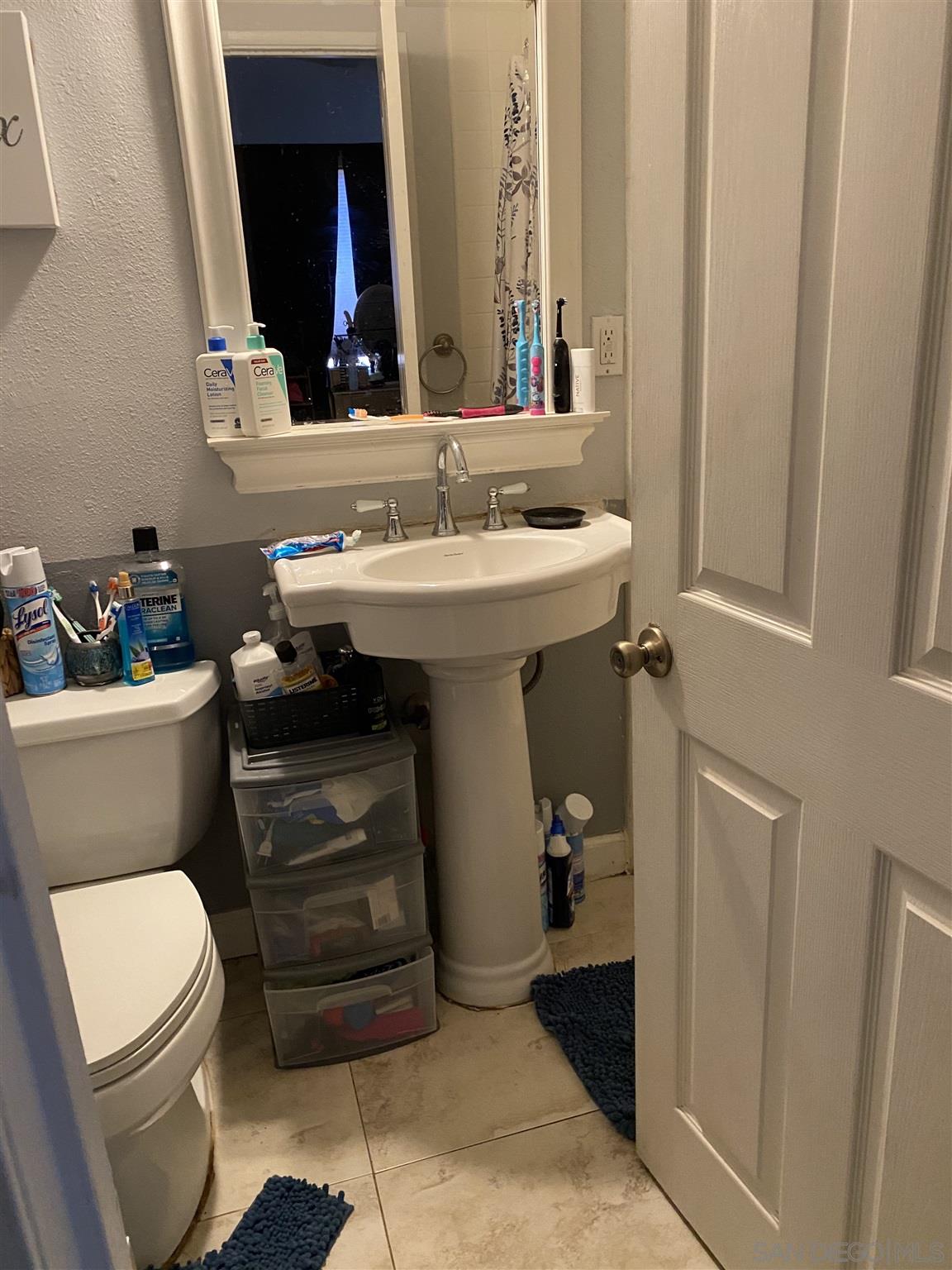 1141 Sumner Avenue El Cajon, CA 92021 - Photo 11 of 32 a bathroom with a sink toilet and mirror