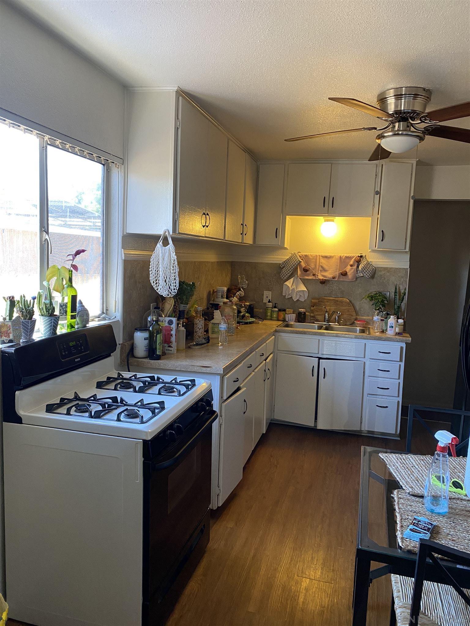 1141 Sumner Avenue El Cajon, CA 92021 - Photo 16 of 32 a kitchen with stainless steel appliances kitchen island granite countertop a stove refrigerator and cabinets