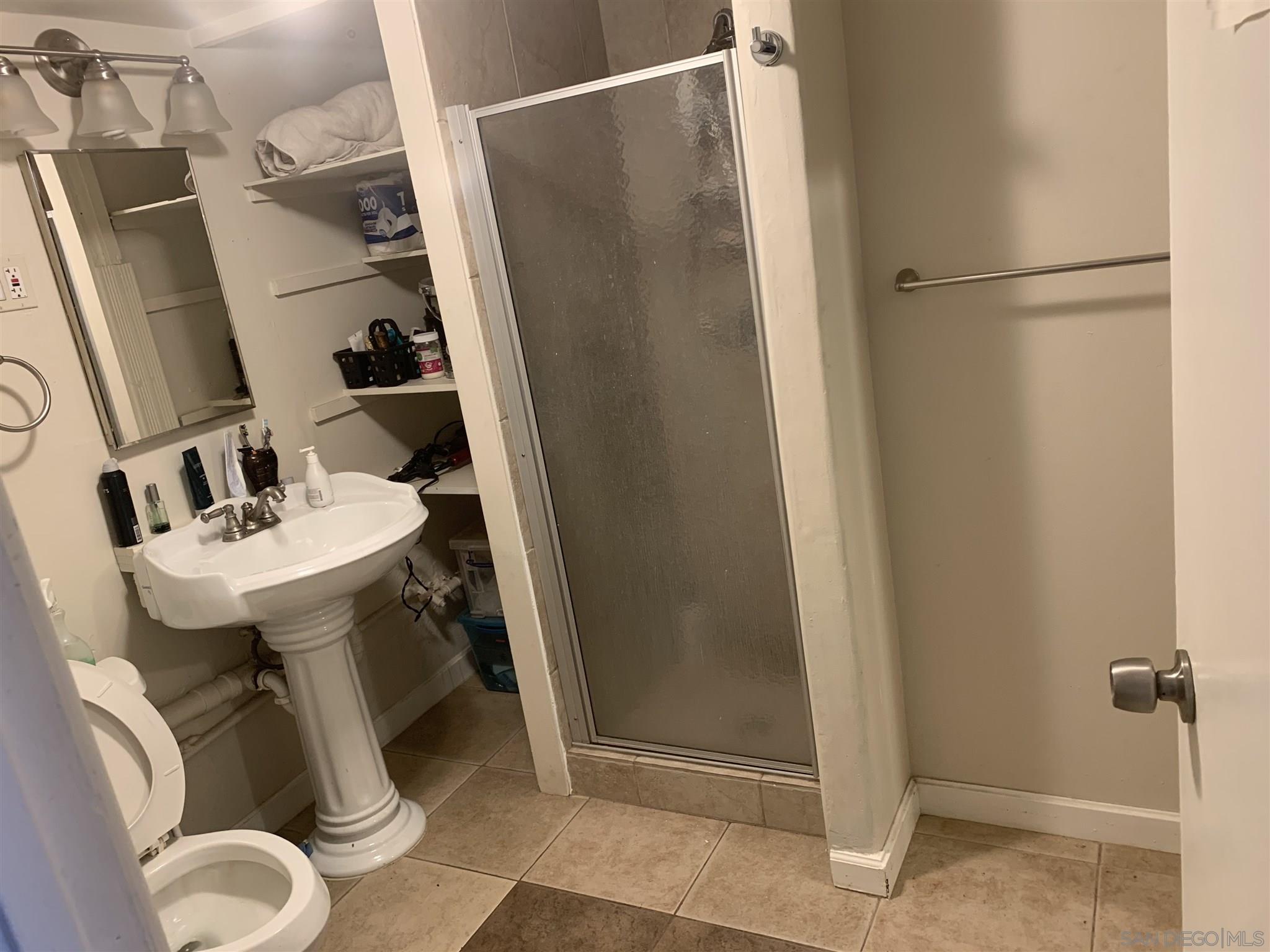 1141 Sumner Avenue El Cajon, CA 92021 - Photo 29 of 32 a bathroom with a sink toilet and shower