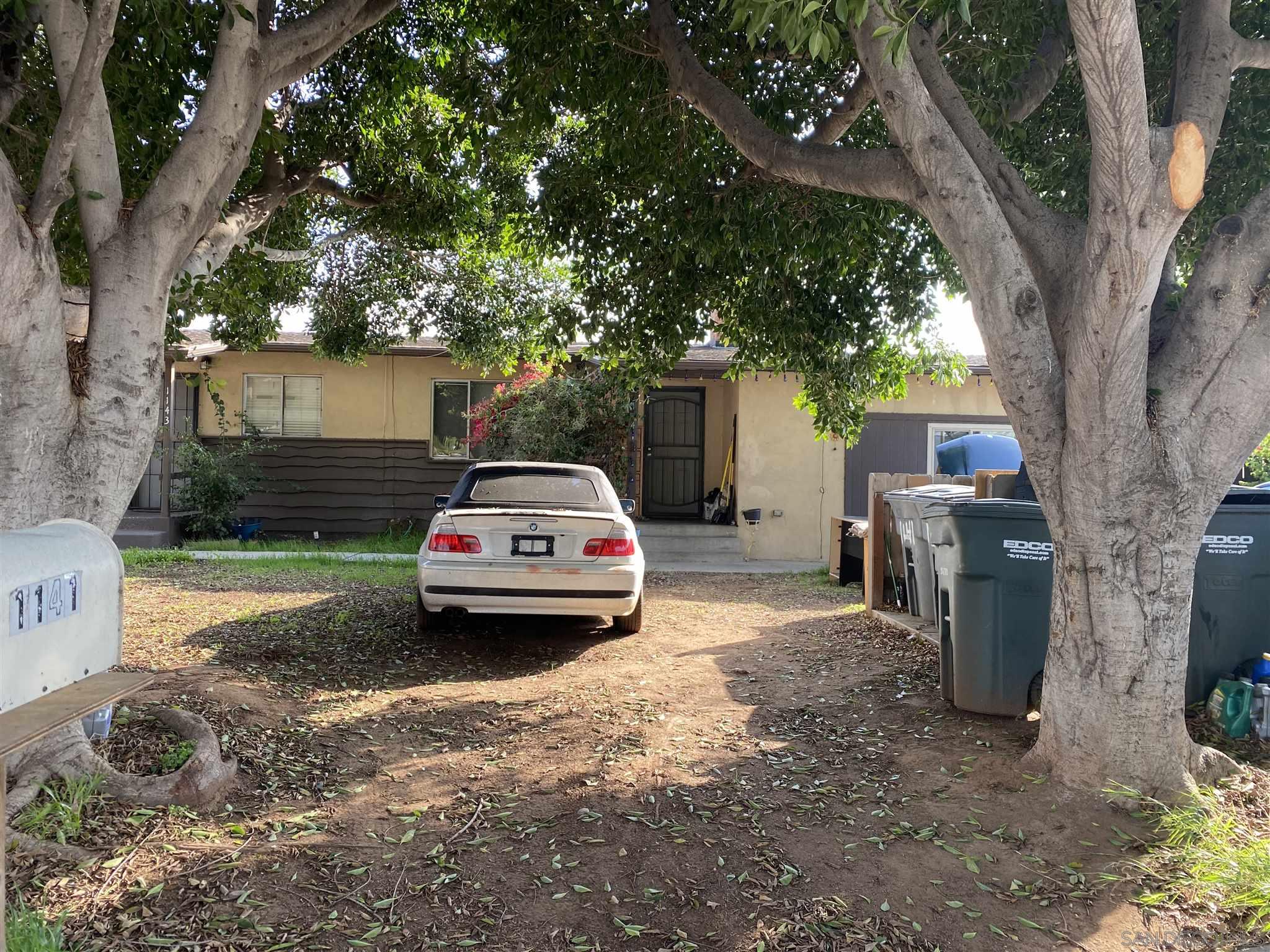 1141 Sumner Avenue El Cajon, CA 92021 - Photo 6 of 32 a view of a car parked in a yard next to a large tree