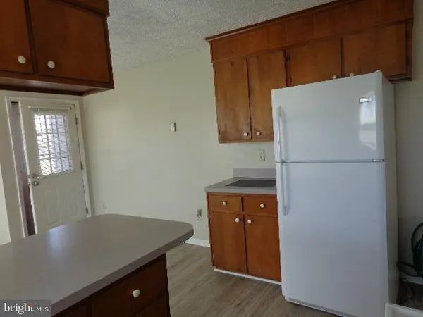 a kitchen with refrigerator and window
